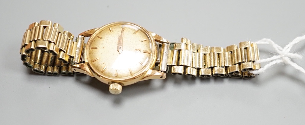 A lady's 18ct gold Omega manual wind wrist watch, on associated gilt bracelet, case diameter 23mm, with Omega guarantee pamphlet.